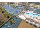 Aerial view of community amenities including tennis courts, pool, playground, and basketball courts at 1406 Deerbourne Dr, Wesley Chapel, FL 33543