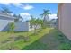 Landscaped backyard with young fruit trees and lake access at 1406 Deerbourne Dr, Wesley Chapel, FL 33543