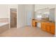 Bright bathroom featuring a walk-in shower and granite-topped vanity at 1406 Deerbourne Dr, Wesley Chapel, FL 33543
