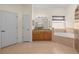 Neutral toned bathroom features a large vanity, soaking tub, and walk in shower at 1406 Deerbourne Dr, Wesley Chapel, FL 33543