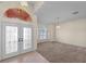 The foyer features tile flooring, a glass paned double door entrance and a spacious, carpeted seating area at 1406 Deerbourne Dr, Wesley Chapel, FL 33543
