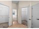Hallway with tile flooring leading to carpeted bedrooms and closets at 1406 Deerbourne Dr, Wesley Chapel, FL 33543
