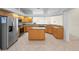 Spacious kitchen with stainless steel appliances, wood cabinets, granite countertops, and a center island at 1406 Deerbourne Dr, Wesley Chapel, FL 33543
