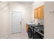 Laundry room with washer, dryer, cabinets, and extra storage at 1406 Deerbourne Dr, Wesley Chapel, FL 33543