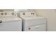 Stackable Whirlpool washer and dryer in laundry room at 1663 Hazy Sea Dr, Plant City, FL 33565