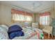 Cozy bedroom with a patchwork quilt and a ceiling fan at 18675 Us Highway 19 N # 125, Clearwater, FL 33764