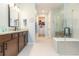 Spa-like bathroom with double sinks, a walk-in shower, and a soaking tub at 19494 Sea Glass Cir, Land O Lakes, FL 34638