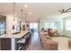 Open concept kitchen and living area with island seating and neutral tones at 19494 Sea Glass Cir, Land O Lakes, FL 34638