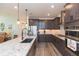 Gourmet kitchen boasting granite countertops and stylish pendant lighting at 19494 Sea Glass Cir, Land O Lakes, FL 34638