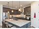 Updated kitchen featuring dark cabinetry and a large island at 19494 Sea Glass Cir, Land O Lakes, FL 34638