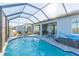Enclosed pool with lake view and patio furniture at 19494 Sea Glass Cir, Land O Lakes, FL 34638