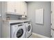 Laundry room with washer, dryer, and extra storage at 20393 Symphony Pl, Venice, FL 34293