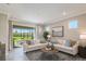 Living area with sliding doors leading to a screened lanai at 20393 Symphony Pl, Venice, FL 34293