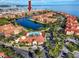 Wide aerial view of waterfront community with pool and clubhouse at 2733 Via Cipriani # 830A, Clearwater, FL 33764