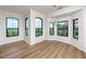 Condo dining area featuring hardwood floors and multiple windows at 2733 Via Cipriani # 830A, Clearwater, FL 33764