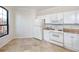 Bright kitchen featuring white cabinetry and tile flooring at 2733 Via Cipriani # 830A, Clearwater, FL 33764