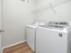 Laundry room with washer, dryer, and shelving at 2733 Via Cipriani # 830A, Clearwater, FL 33764