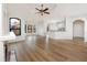 Open living area with hardwood floors and kitchen island at 2733 Via Cipriani # 830A, Clearwater, FL 33764
