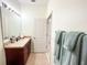 Bathroom with wood vanity, single sink and light teal towels at 30405 Elderwood Dr, Wesley Chapel, FL 33543