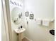 Simple bathroom with pedestal sink and oval mirror at 30405 Elderwood Dr, Wesley Chapel, FL 33543