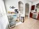 Stylish kitchen coffee bar with glass shelving and accessories at 30405 Elderwood Dr, Wesley Chapel, FL 33543