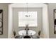 Bright dining area with glass table and four chairs at 30405 Elderwood Dr, Wesley Chapel, FL 33543