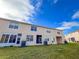 Wider view of the home's exterior and backyard at 30405 Elderwood Dr, Wesley Chapel, FL 33543