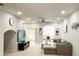 Open living area with sectional sofa and large TV at 30405 Elderwood Dr, Wesley Chapel, FL 33543