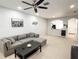 Spacious living room with gray sectional sofa and coffee table at 30405 Elderwood Dr, Wesley Chapel, FL 33543