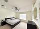Large main bedroom with king-size bed and ceiling fan at 30405 Elderwood Dr, Wesley Chapel, FL 33543