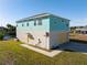 Two-story house with light teal siding, yellow garage door, and a walkway at 3500 Casa Ct, Hernando Beach, FL 34607