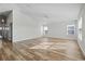 Spacious living room with wood-look flooring and large windows at 3500 Casa Ct, Hernando Beach, FL 34607