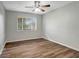 Well-lit bedroom with wood-look floors and a ceiling fan at 7020 Cognac Dr # 3, New Port Richey, FL 34653