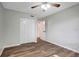 Spacious bedroom with wood-look flooring and ceiling fan at 7020 Cognac Dr # 3, New Port Richey, FL 34653