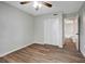 Bedroom with wood-look floors, ceiling fan and access to bathroom at 7020 Cognac Dr # 3, New Port Richey, FL 34653