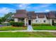 Inviting exterior of a two-story condo with landscaped grounds at 7020 Cognac Dr # 3, New Port Richey, FL 34653