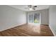 Bright living room with wood-look floors and access to balcony at 7020 Cognac Dr # 3, New Port Richey, FL 34653