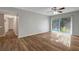 Living room with wood-look floors and access to balcony and hallway at 7020 Cognac Dr # 3, New Port Richey, FL 34653