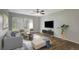 Spacious living room featuring wood-look floors and modern furnishings at 7020 Cognac Dr # 3, New Port Richey, FL 34653
