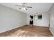 Living room with kitchen pass-through and wood-look floors at 7020 Cognac Dr # 3, New Port Richey, FL 34653