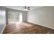Bright living room featuring wood-look floors and sliding glass doors to balcony at 7020 Cognac Dr # 3, New Port Richey, FL 34653