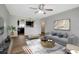 Living room with kitchen pass-through and wood-look floors at 7020 Cognac Dr # 3, New Port Richey, FL 34653
