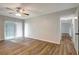 Living room with wood-look floors, access to balcony and hallway at 7020 Cognac Dr # 3, New Port Richey, FL 34653