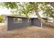 Rear view of a gray house with mature tree at 7132 Lockwood St, Spring Hill, FL 34606