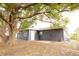 Rear view of gray house with shed and patio at 7132 Lockwood St, Spring Hill, FL 34606