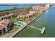 Waterfront condominium complex featuring a community pool and dock access on a sunny day at 7550 Sunshine Skyway S Ln # T48, St Petersburg, FL 33711