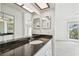 Bathroom boasts granite countertop, white cabinets, and great lighting at 7550 Sunshine Skyway S Ln # T48, St Petersburg, FL 33711