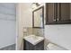 Bathroom features mosaic backsplash and cabinet storage at 7550 Sunshine Skyway S Ln # T48, St Petersburg, FL 33711
