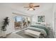Bright bedroom with ceiling fan, balcony and water view at 7550 Sunshine Skyway S Ln # T48, St Petersburg, FL 33711