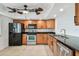 Well-equipped kitchen featuring stainless steel appliances, wood cabinets, and ample counter space at 7550 Sunshine Skyway S Ln # T48, St Petersburg, FL 33711